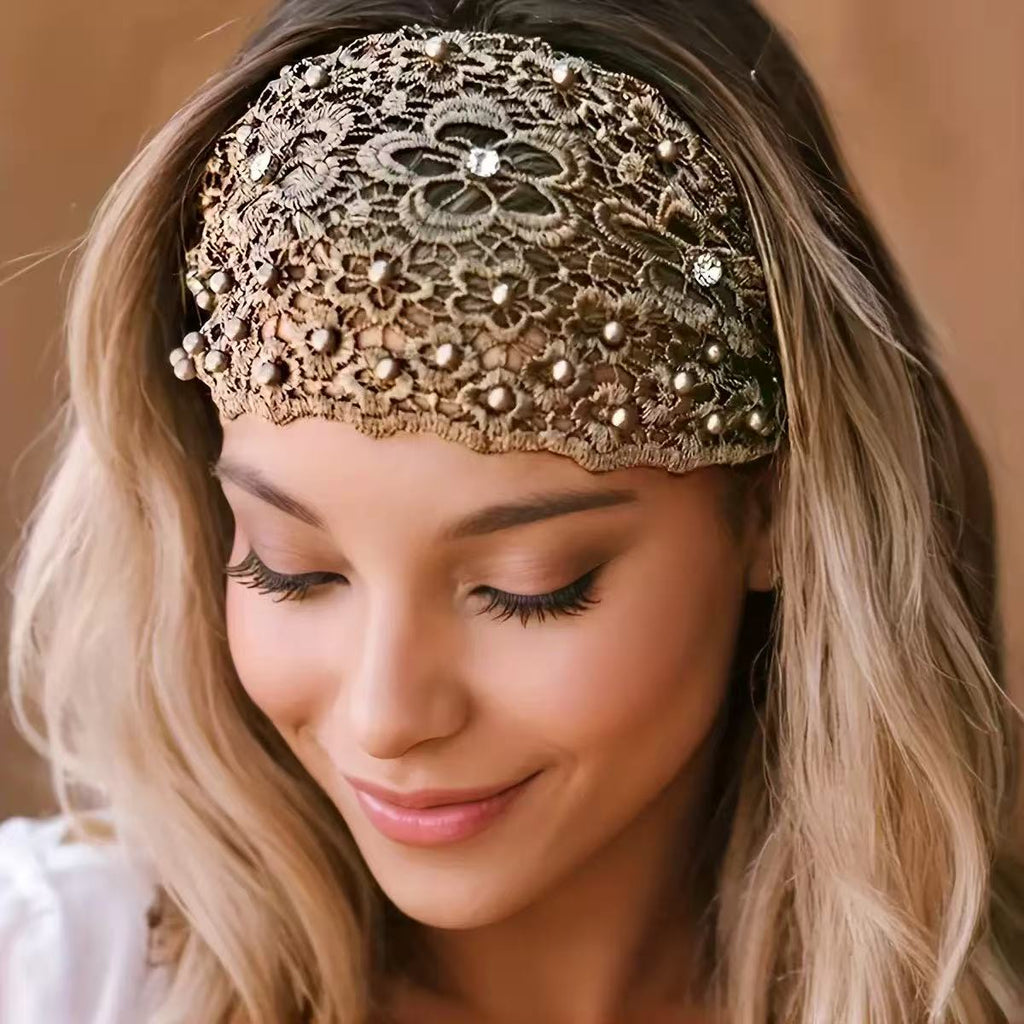 Woman wearing a decorative lace headband with beads against a neutral background